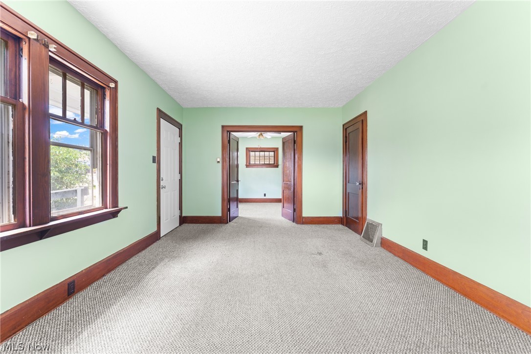 16 South State Street Rittman, OH 44270 - Photo 10 of 27 Empty room featuring light carpet and a textured ceiling