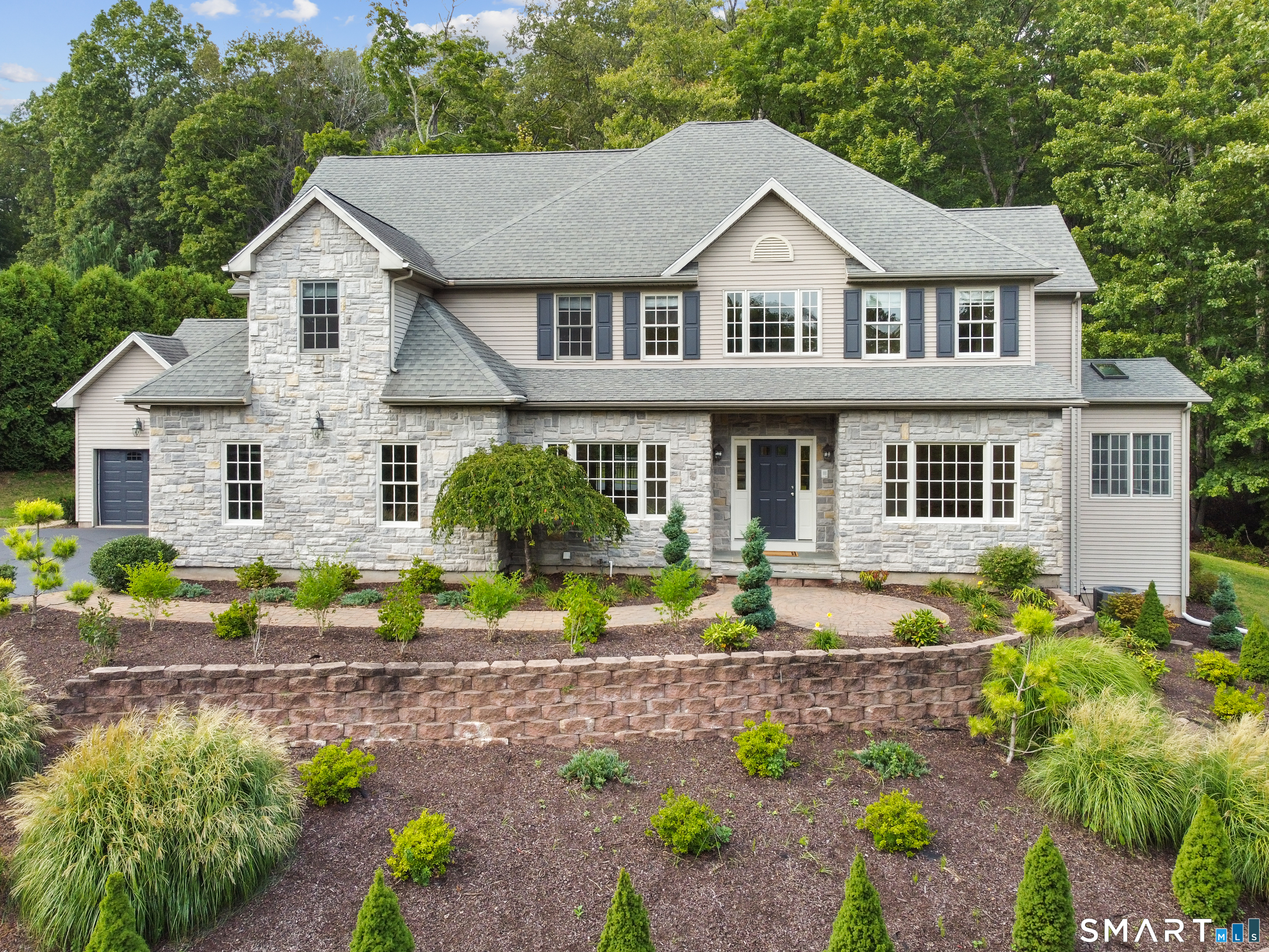 7 Mountainside Road West Hartford, CT 06117 - Photo 1 of 40 a front view of a house with a garden