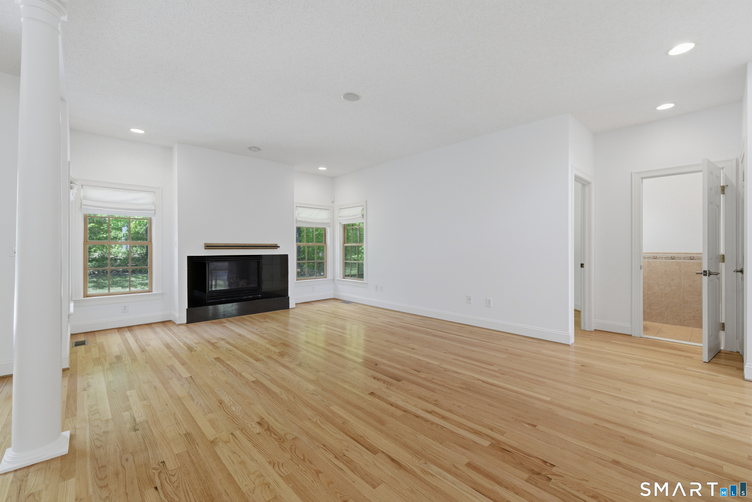 7 Mountainside Road West Hartford, CT 06117 - Photo 11 of 40 a view of empty room with wooden floor and fireplace