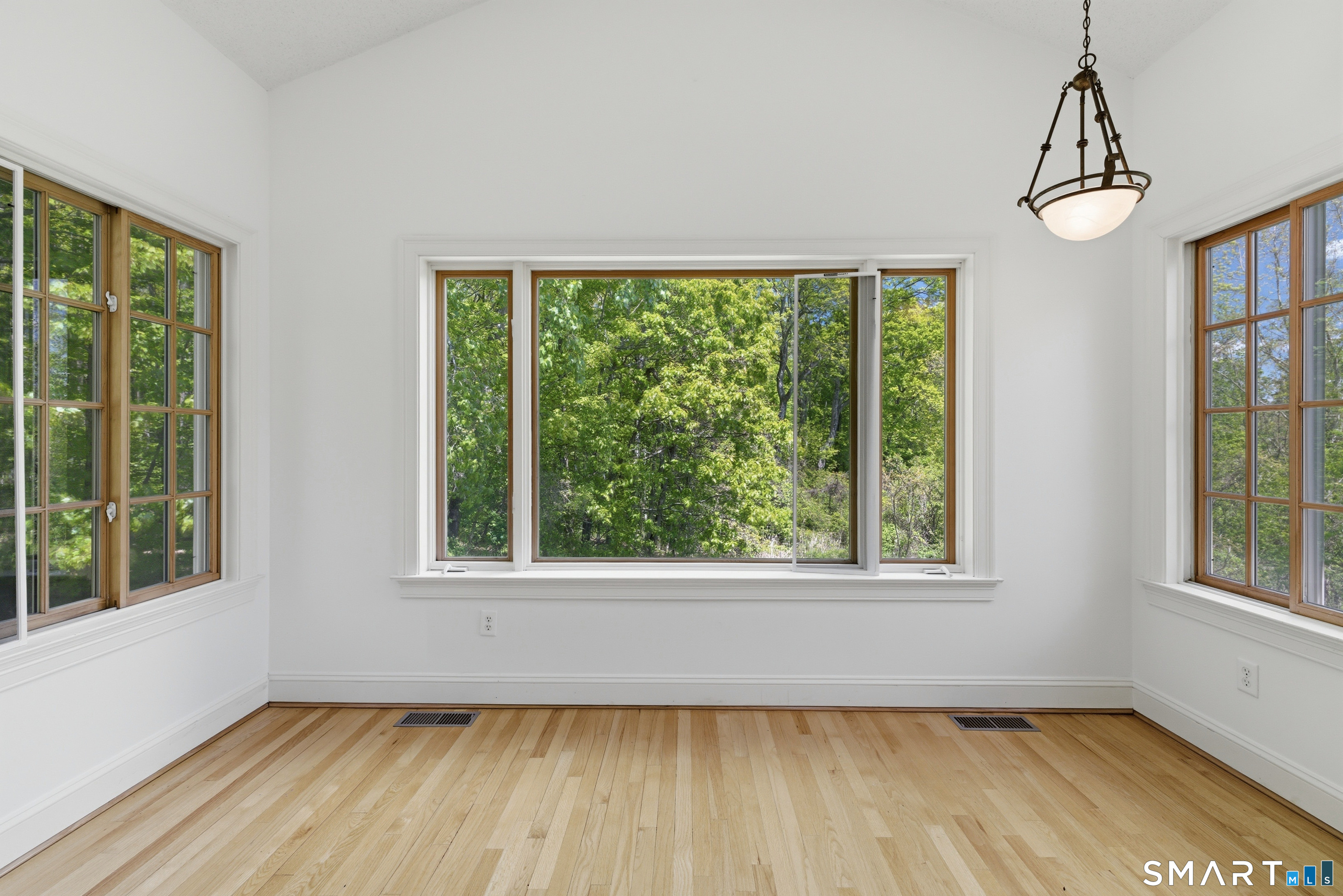 7 Mountainside Road West Hartford, CT 06117 - Photo 20 of 40 a view of an empty room with a window and wooden floor