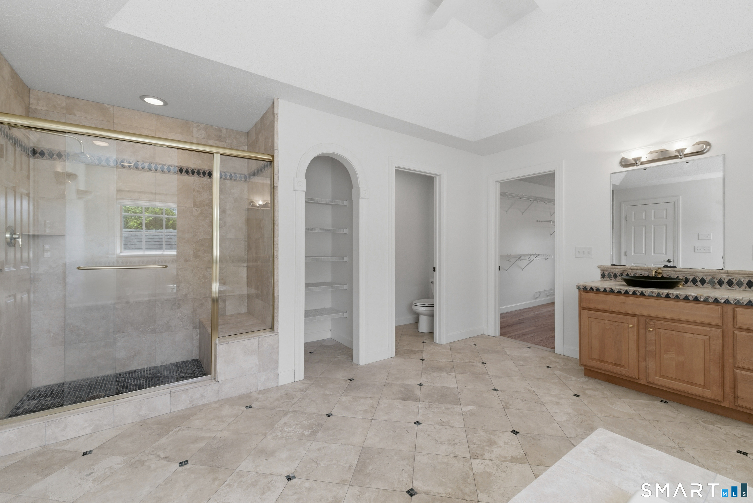 7 Mountainside Road West Hartford, CT 06117 - Photo 25 of 40 a bathroom with a granite countertop sink a mirror and a shower