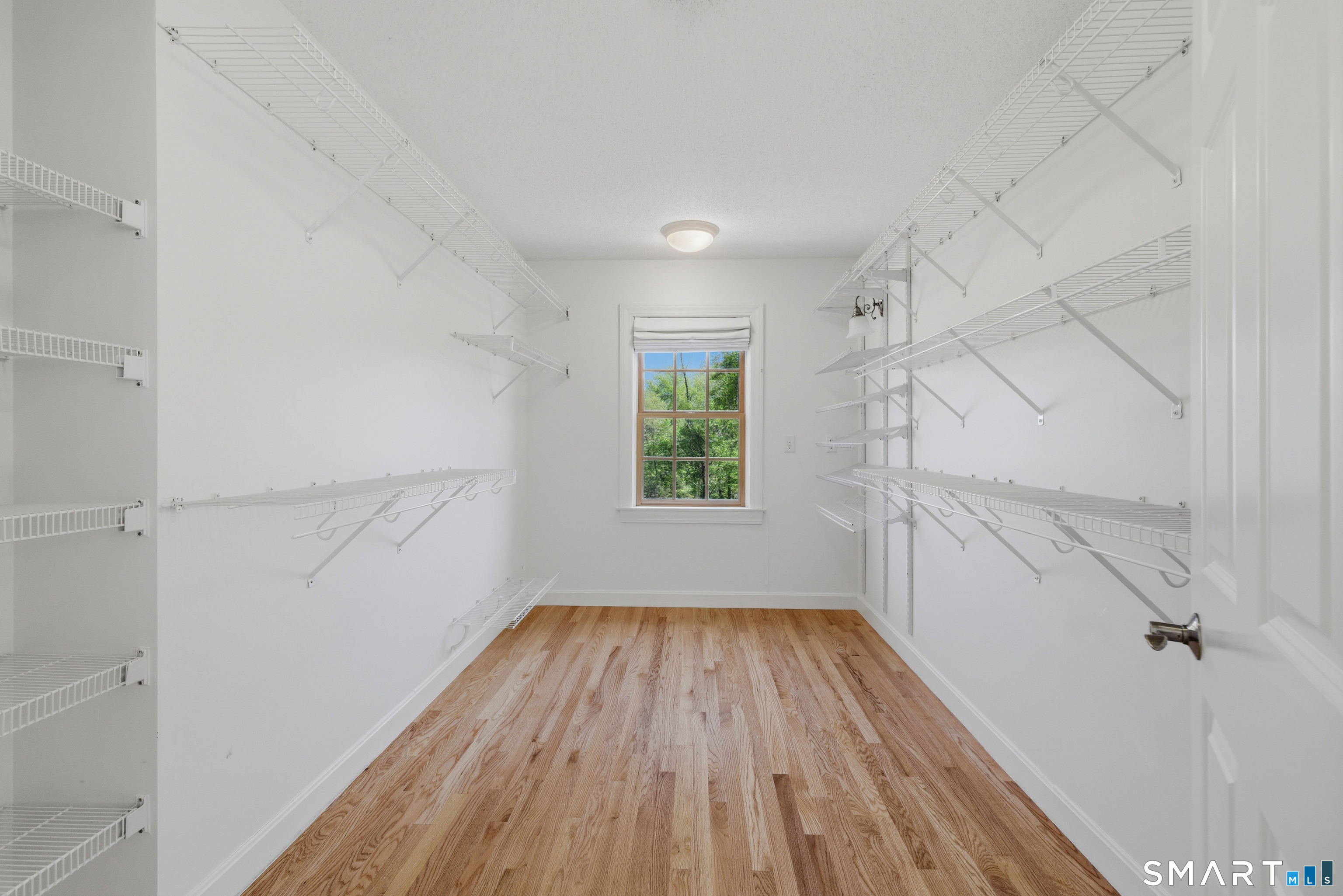 7 Mountainside Road West Hartford, CT 06117 - Photo 26 of 40 a view of hallway with a large window and wooden floor