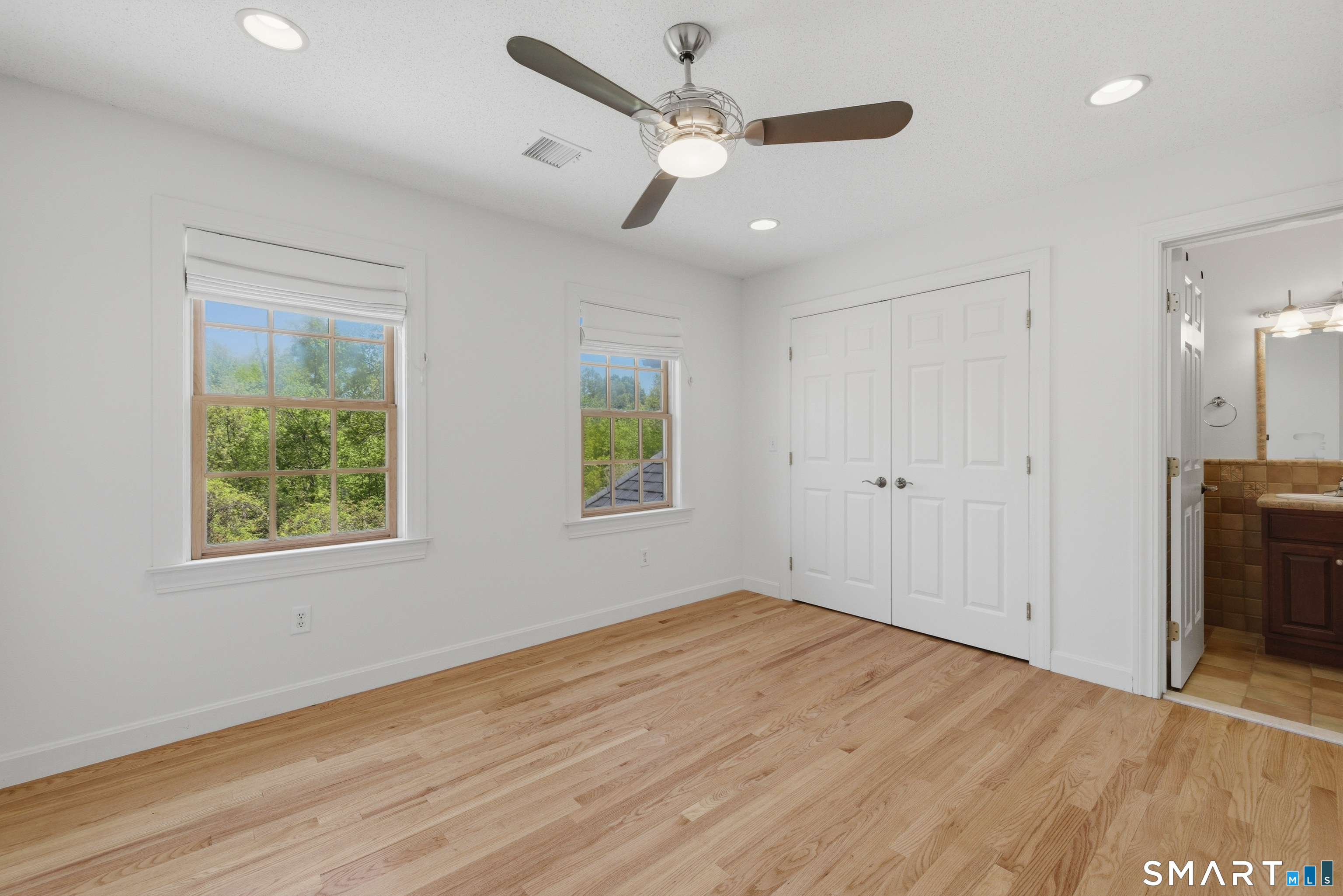 7 Mountainside Road West Hartford, CT 06117 - Photo 28 of 40 a view of an empty room with wooden floor and a window