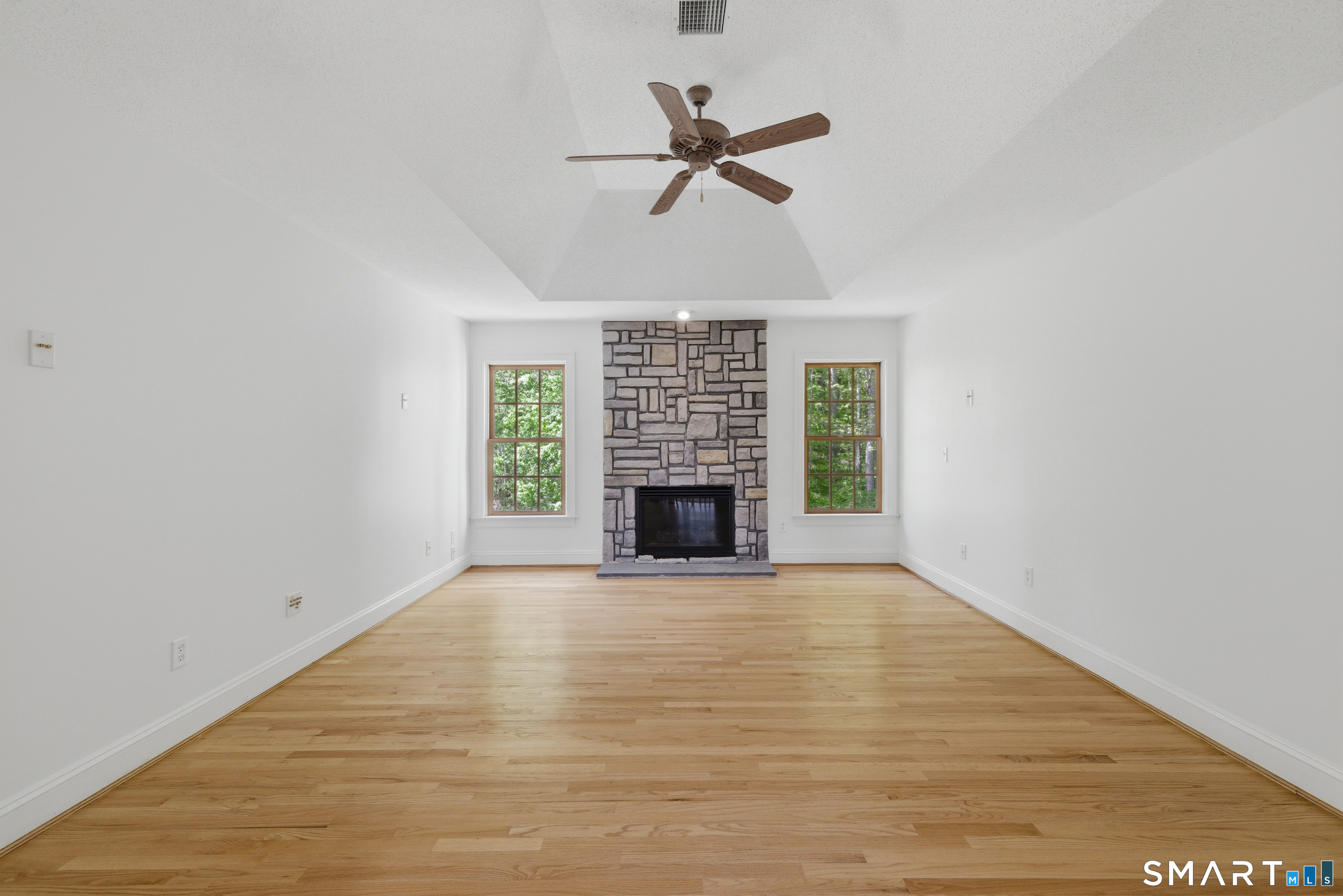 7 Mountainside Road West Hartford, CT 06117 - Photo 33 of 40 a view of a livingroom with a ceiling fan and hardwood floor