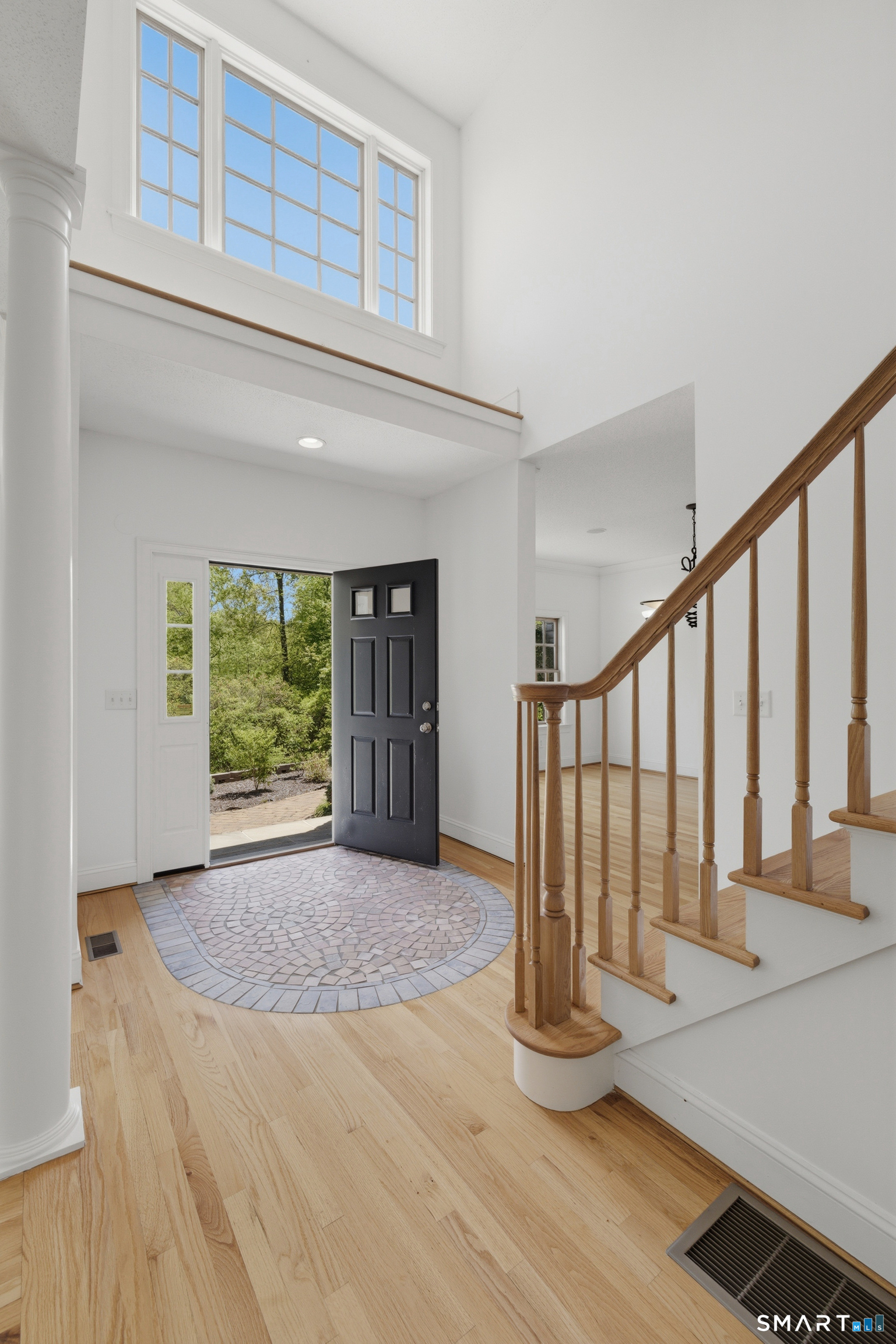 7 Mountainside Road West Hartford, CT 06117 - Photo 4 of 40 a view of an entryway with wooden floor and door