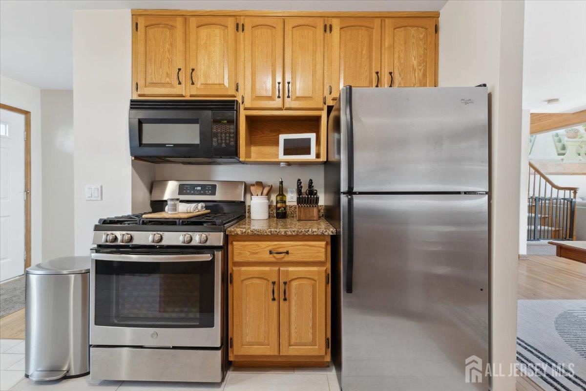 675 Raritan Road Clark, NJ 07066 - Photo 8 of 58 a kitchen with stainless steel appliances granite countertop a refrigerator stove and sink