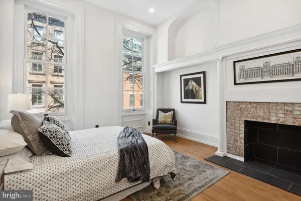 a spacious bedroom with a bed and a fireplace