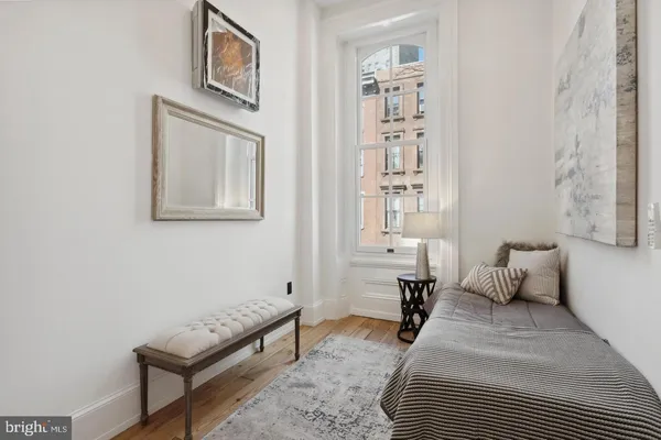 a bedroom with furniture and a lamp