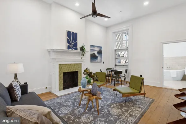 a living room with furniture and a fireplace