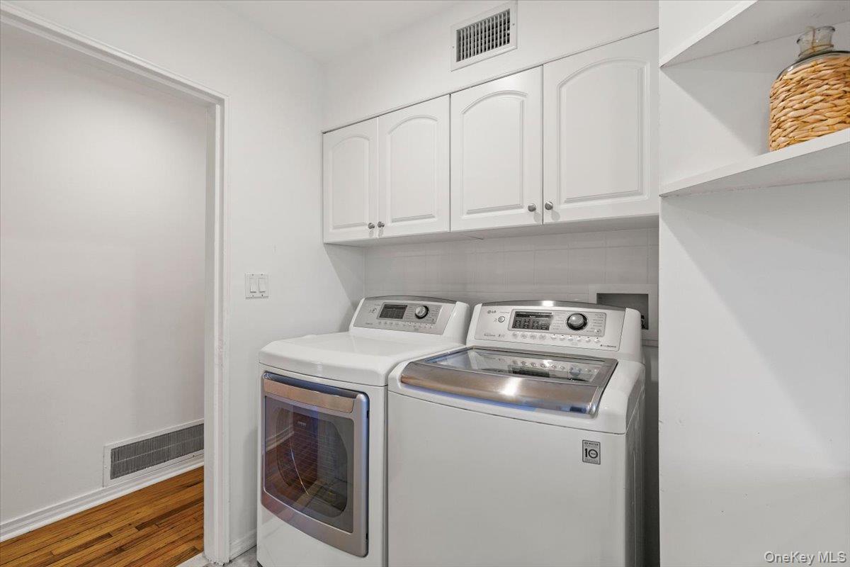 22 Old Orchard Road Rye Brook, NY 10573 - Photo 12 of 30 Laundry area with cabinet space, washing machine and clothes dryer