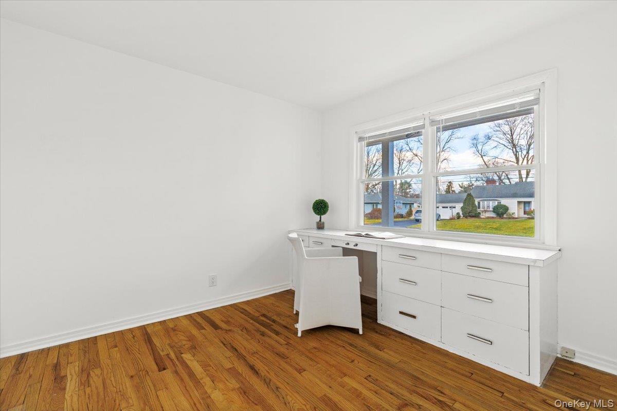 22 Old Orchard Road Rye Brook, NY 10573 - Photo 17 of 30 One of the first floor bedrooms features a built-in desk, shelves, and closet