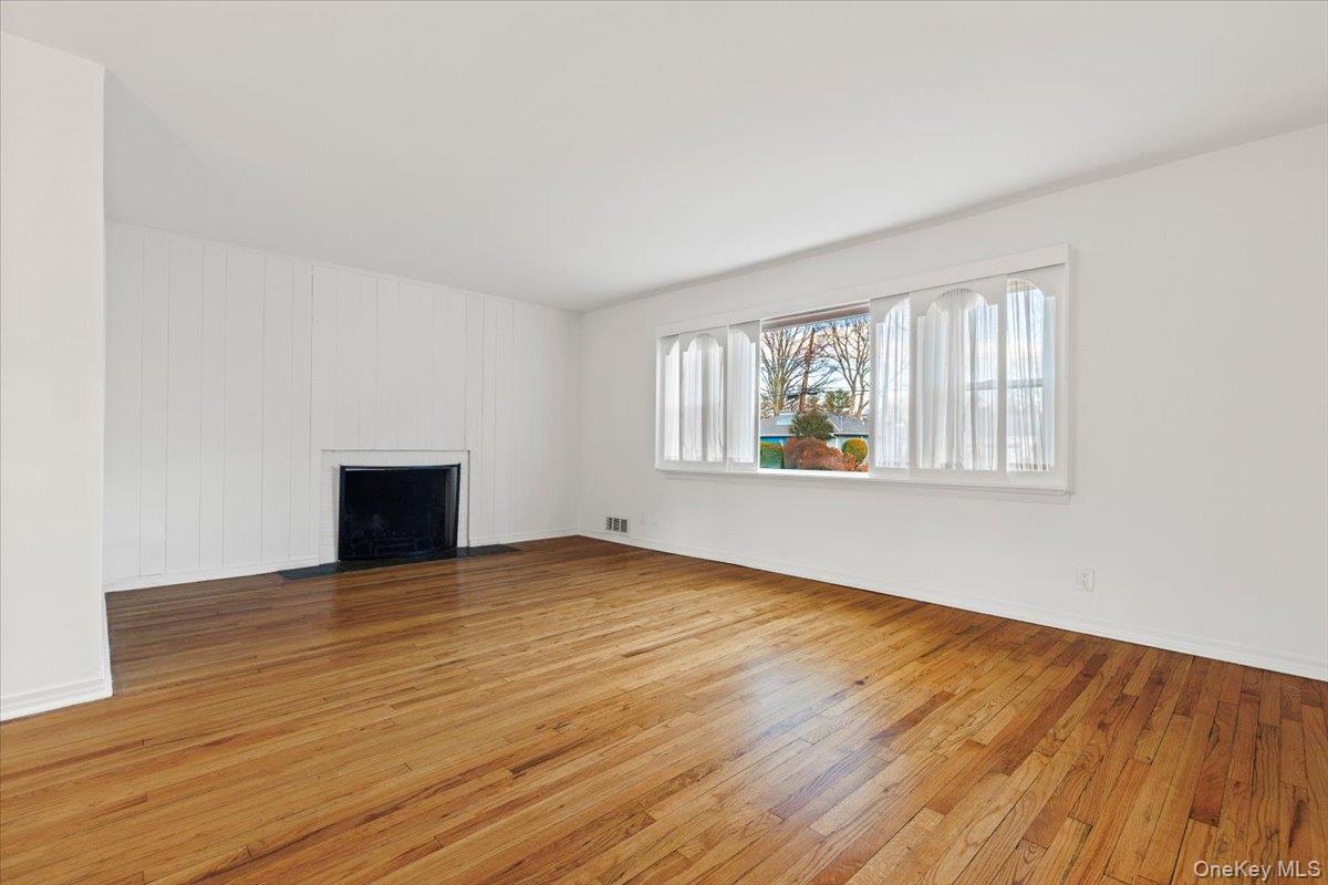 22 Old Orchard Road Rye Brook, NY 10573 - Photo 4 of 30 Spacious living room offers gracious seating space with large picture window and wood burning fireplace
