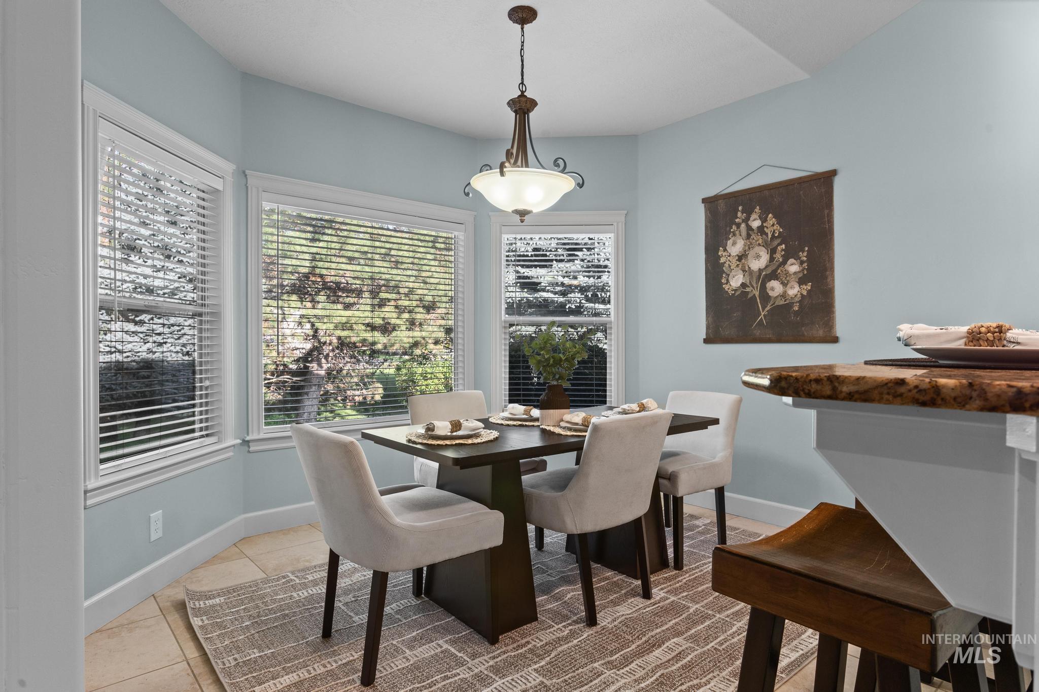 4946 North Villa Ridge Way Boise, ID 83703 - Photo 15 of 49 Dining area featuring a contemporary chandelier and tiled flooring