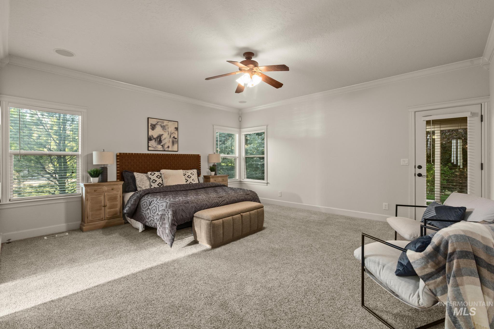 4946 North Villa Ridge Way Boise, ID 83703 - Photo 17 of 49 Spacious room featuring light-toned carpeting, multiple large windows, and a glass-paneled exterior door