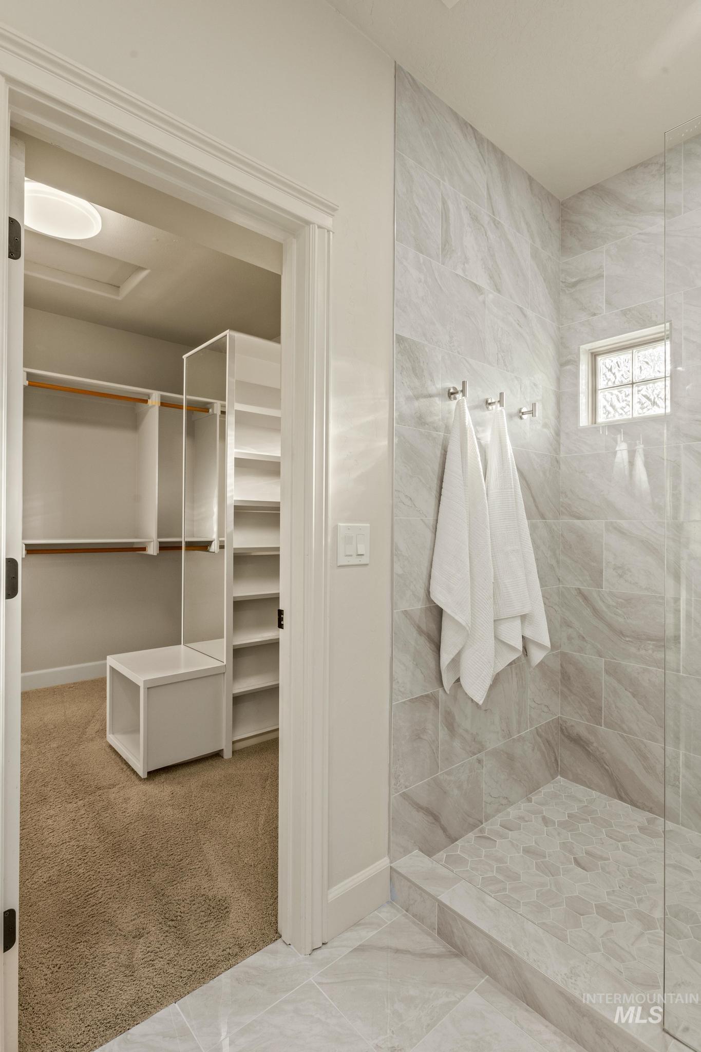 4946 North Villa Ridge Way Boise, ID 83703 - Photo 24 of 49 Spacious bathroom featuring a glass-enclosed shower with large format tile walls and a hexagonal tile floor