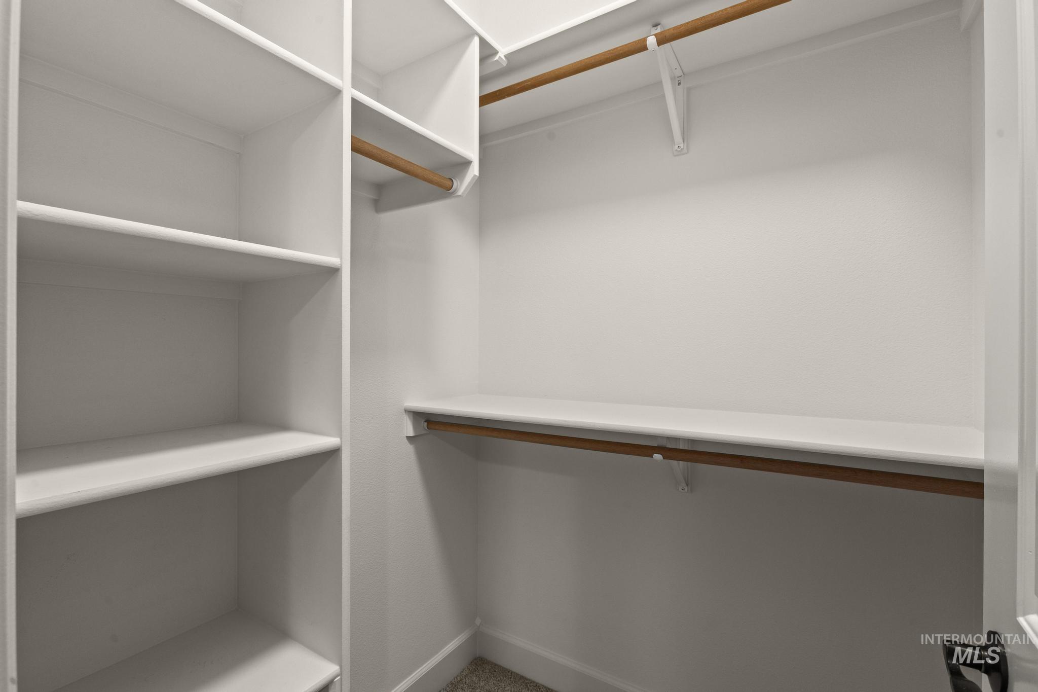4946 North Villa Ridge Way Boise, ID 83703 - Photo 31 of 49 Walk-in closet with built-in shelving, multiple hanging rods, and a white finish