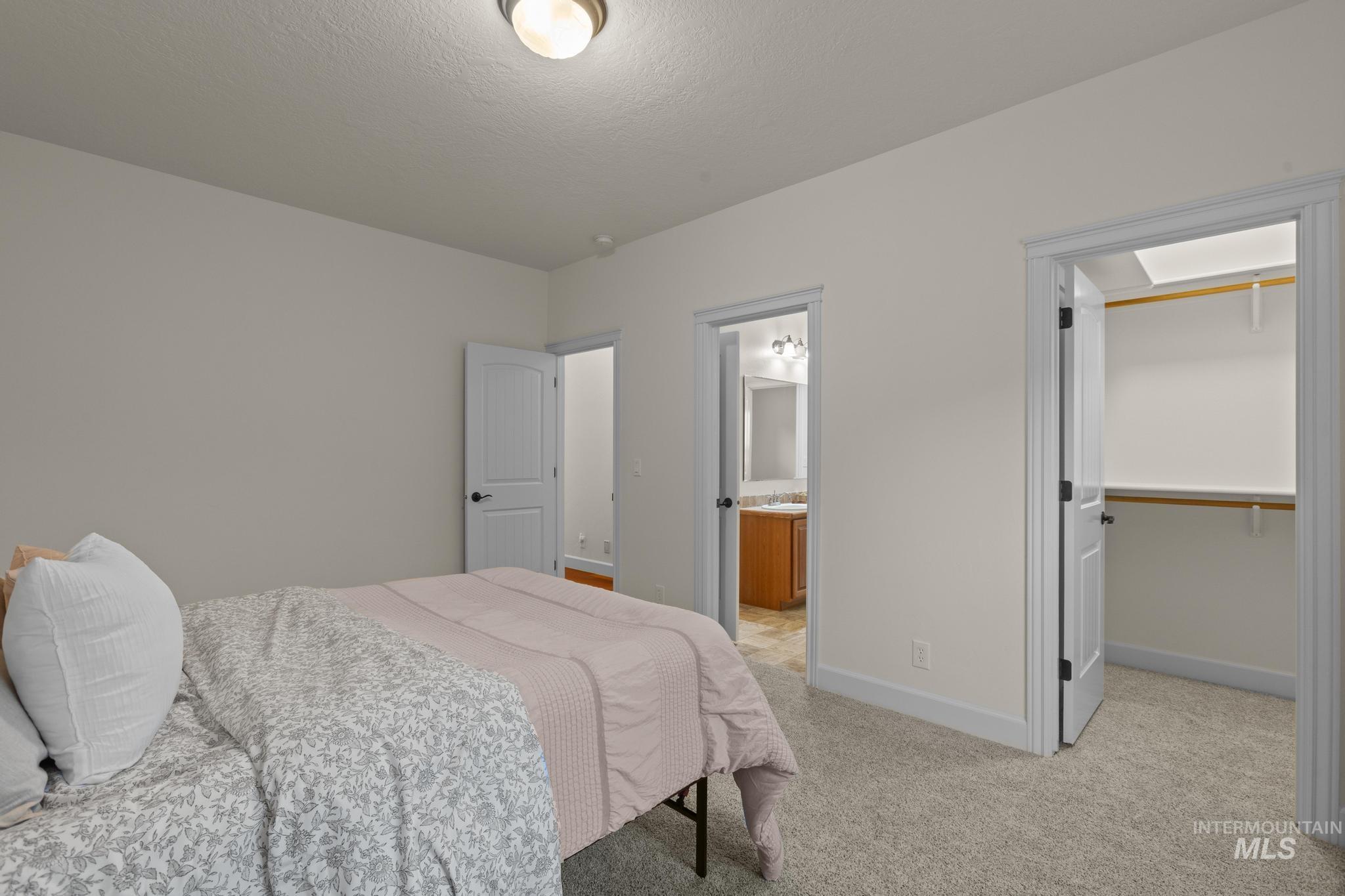 4946 North Villa Ridge Way Boise, ID 83703 - Photo 36 of 49 Bedroom featuring light gray wall paint, neutral carpeting, and white trim