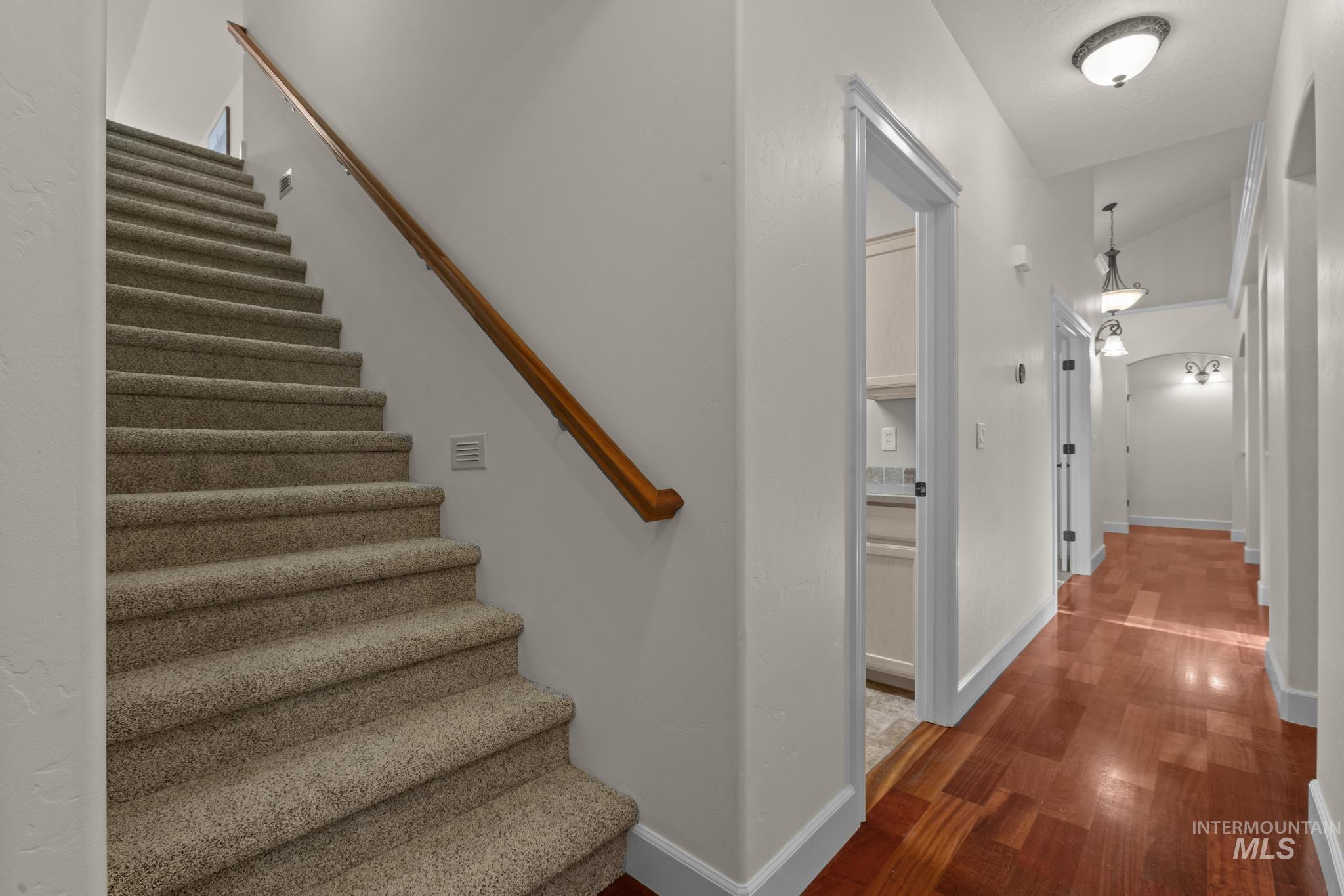 4946 North Villa Ridge Way Boise, ID 83703 - Photo 38 of 49 Staircase with carpeted treads and a wood handrail