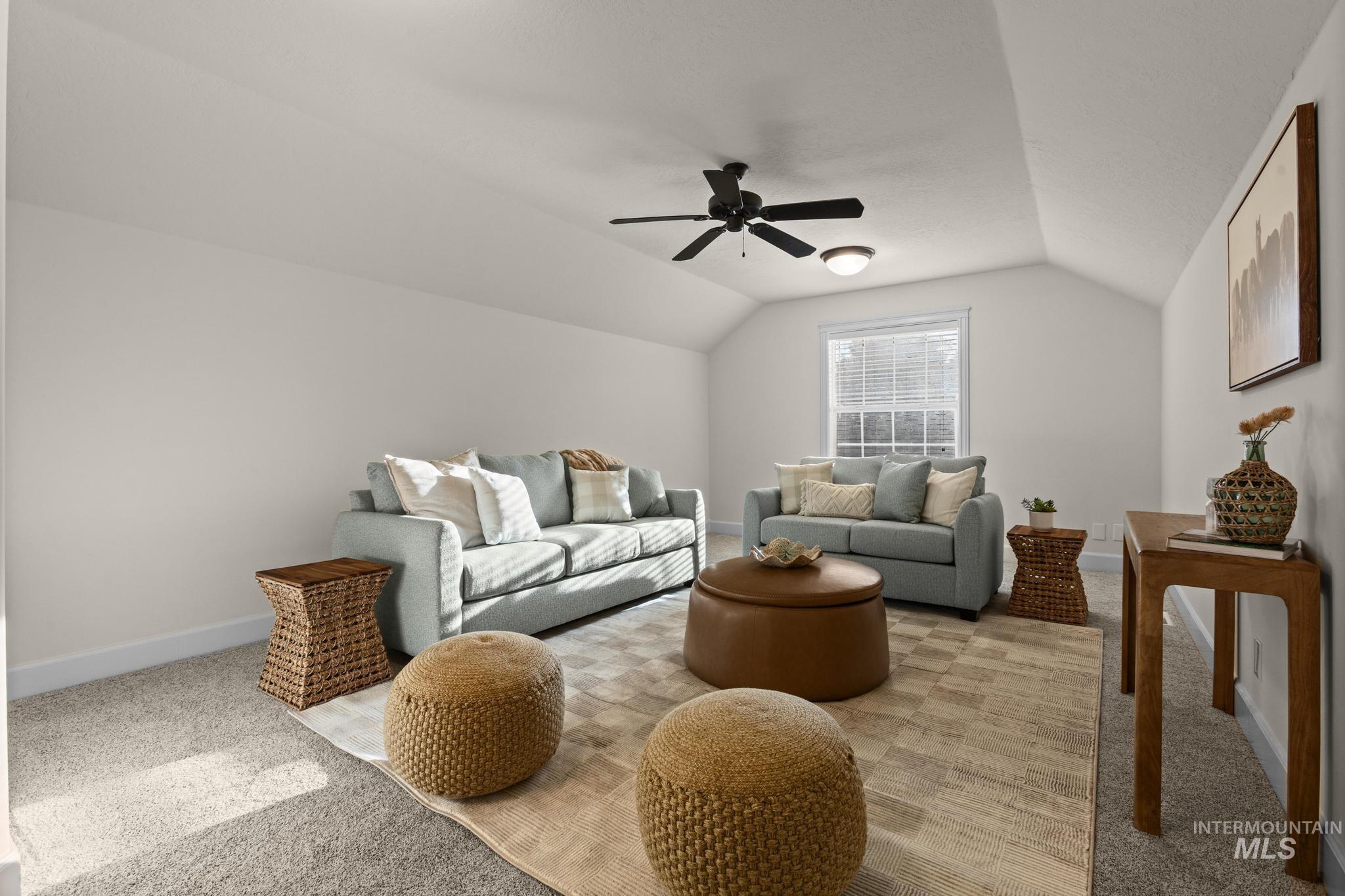 4946 North Villa Ridge Way Boise, ID 83703 - Photo 39 of 49 Spacious room featuring vaulted ceilings, neutral-toned carpeting, and a ceiling fan with integrated lighting