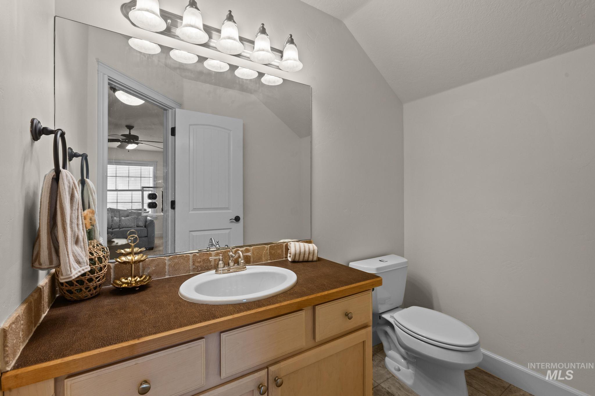4946 North Villa Ridge Way Boise, ID 83703 - Photo 41 of 49 Spacious vanity featuring a light wood-finish base, integrated sink, and a multi-light fixture