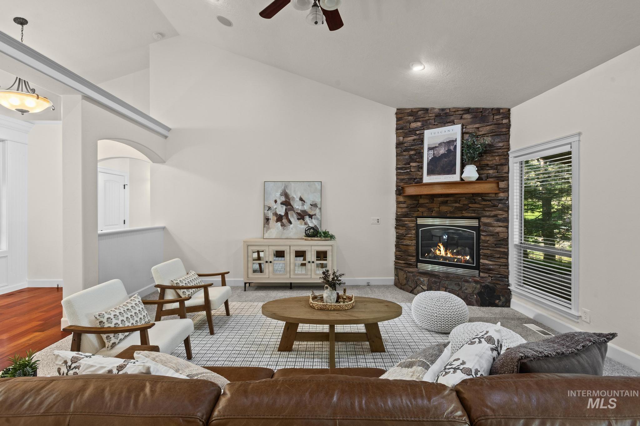 4946 North Villa Ridge Way Boise, ID 83703 - Photo 6 of 49 Vaulted living room with a stone-clad fireplace and wood mantle