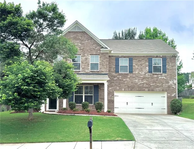 a front view of a house with a yard