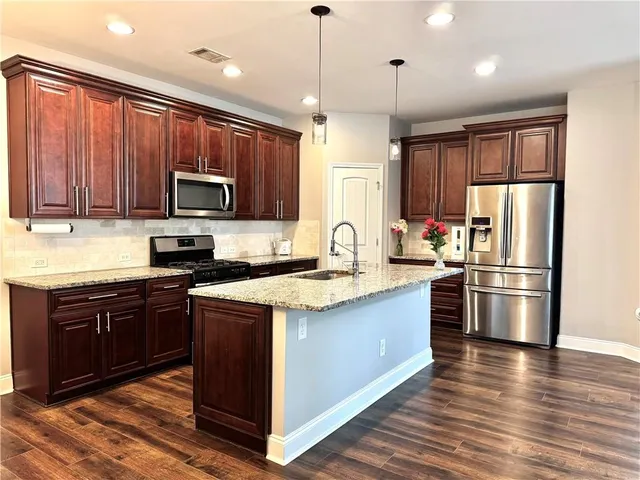 a kitchen with stove and cabinets