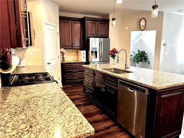 a kitchen with sink dining table and chairs