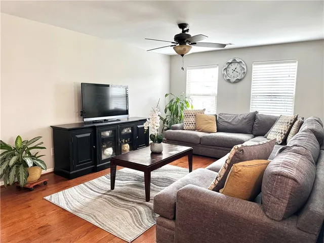 a living room with furniture and a large window