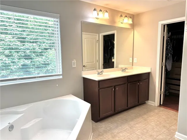 a bathroom with a tub and shower