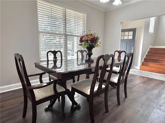 a view of a dining room with furniture and chandelier