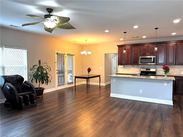 a kitchen with sink cabinets and chandelier