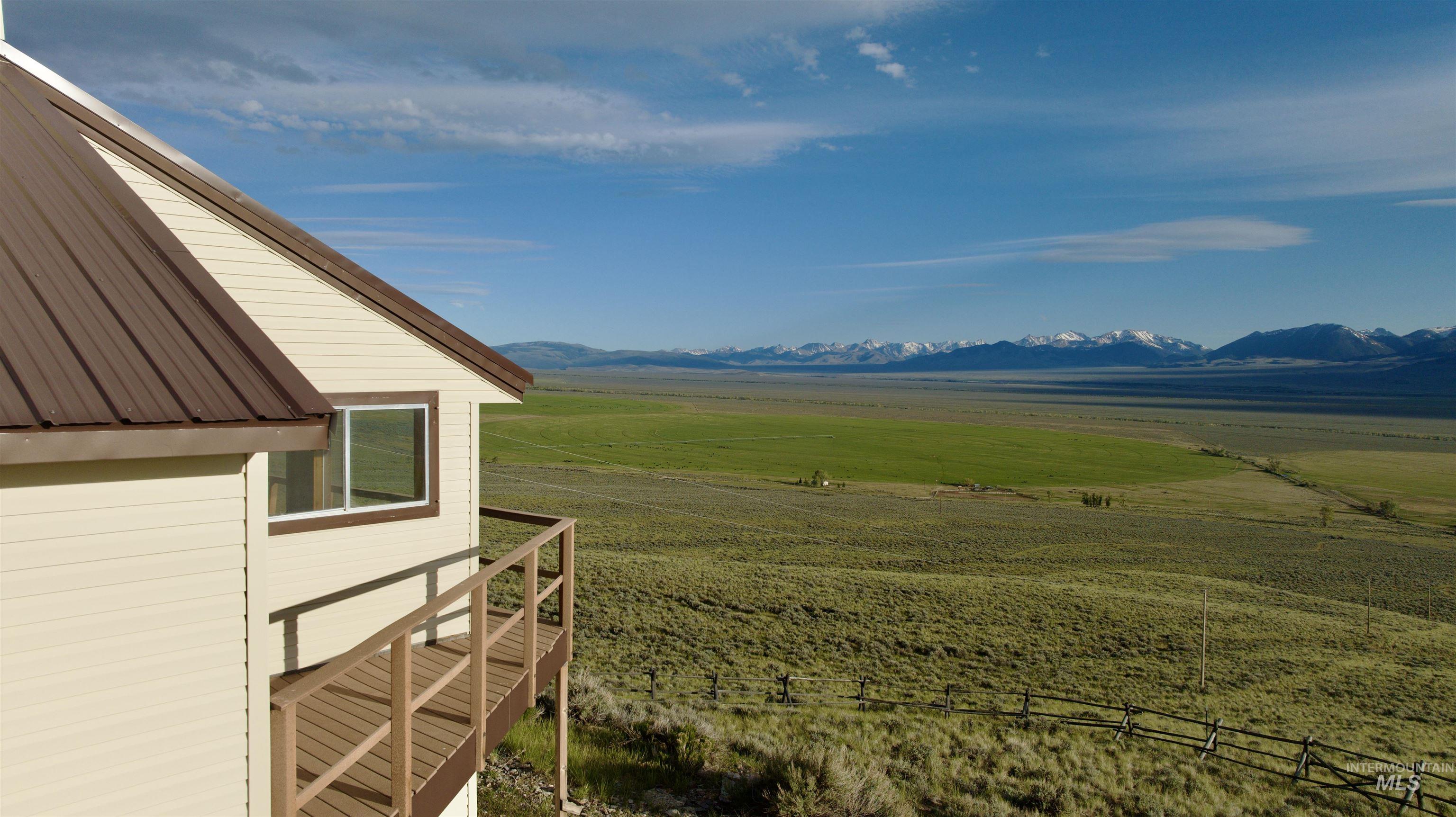 2040 Pahsimeroi River Road May, ID 83253 - Photo 24 of 29 Cream siding exterior with a brown metal roof
