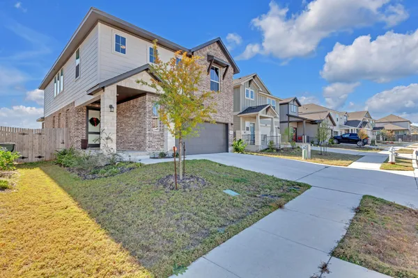 a front view of a house with a yard