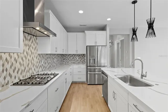 a kitchen with a sink and a wooden floor