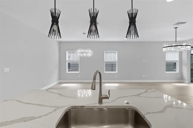 an empty room with a window and a ceiling fan