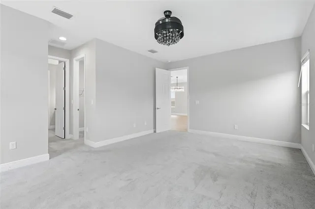 a bathroom with a granite countertop sink a toilet and a mirror