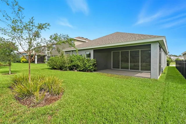 a view of a house with swimming pool and sitting area