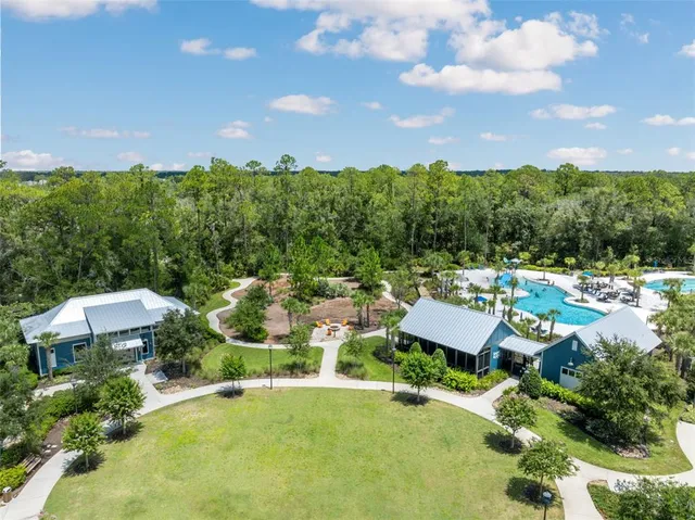a view of a swimming pool with a lot of trees in the background