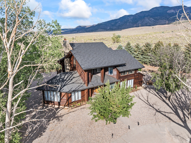 460 Omni Point Road Central Valley, UT 84754 - Photo 99 of 101 Stained wood-sided residence featuring a dark shingle roof and multiple windows