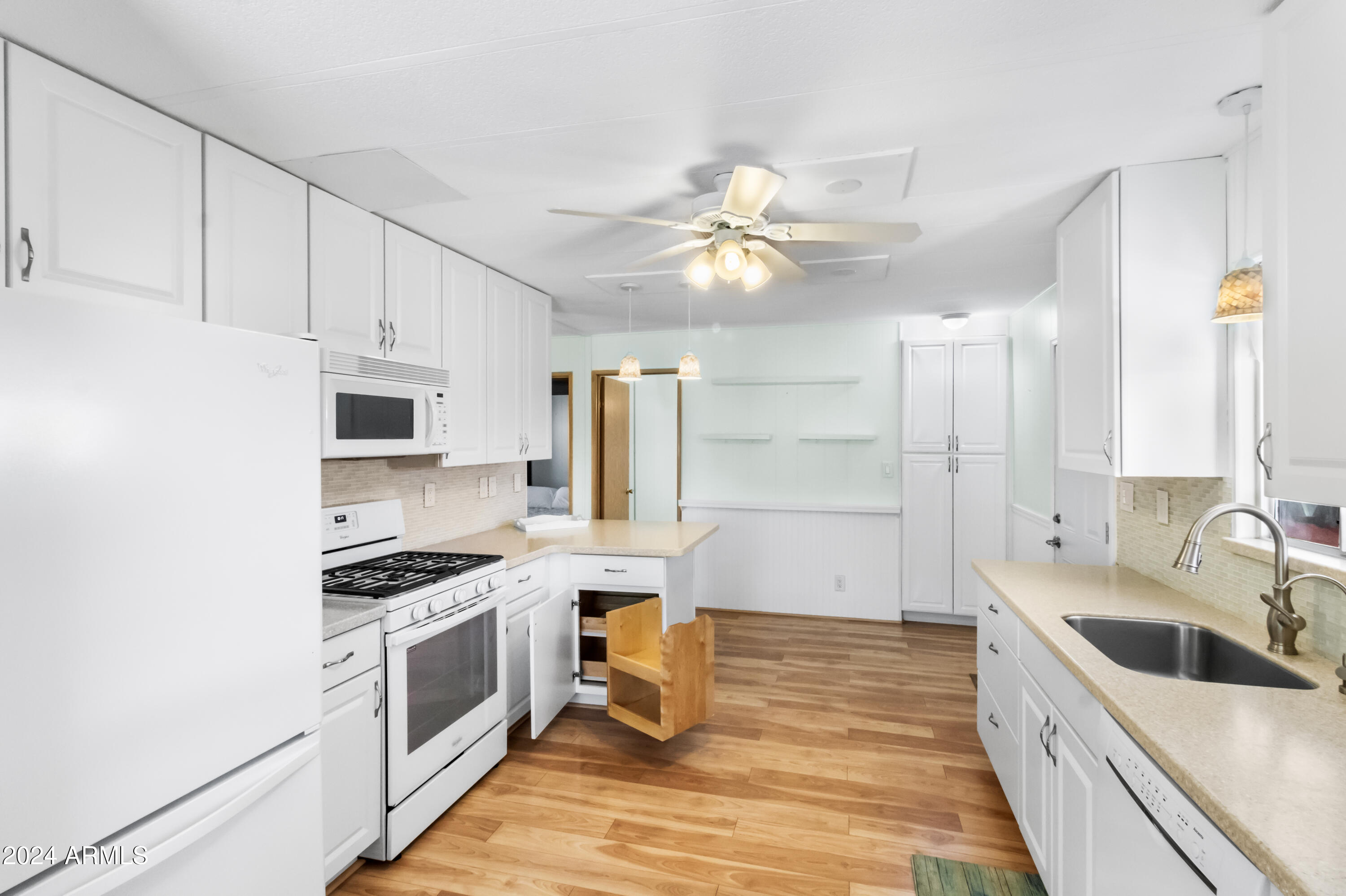 2100 North Trekell Road, Unit 204 Casa Grande, AZ 85122 - Photo 10 of 27 a kitchen with stainless steel appliances a stove a sink and a refrigerator