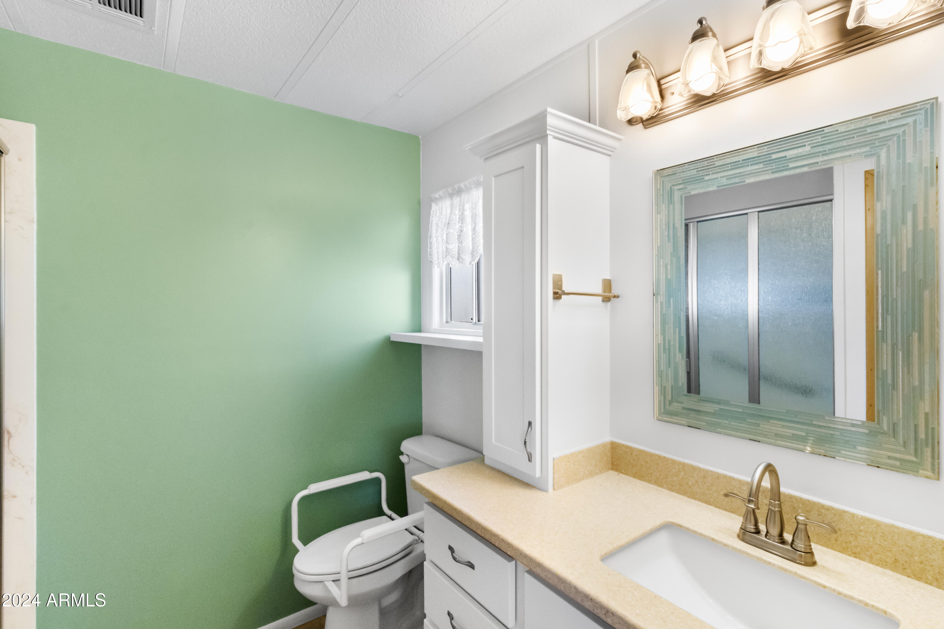 2100 North Trekell Road, Unit 204 Casa Grande, AZ 85122 - Photo 16 of 27 a bathroom with a granite countertop sink toilet and mirror