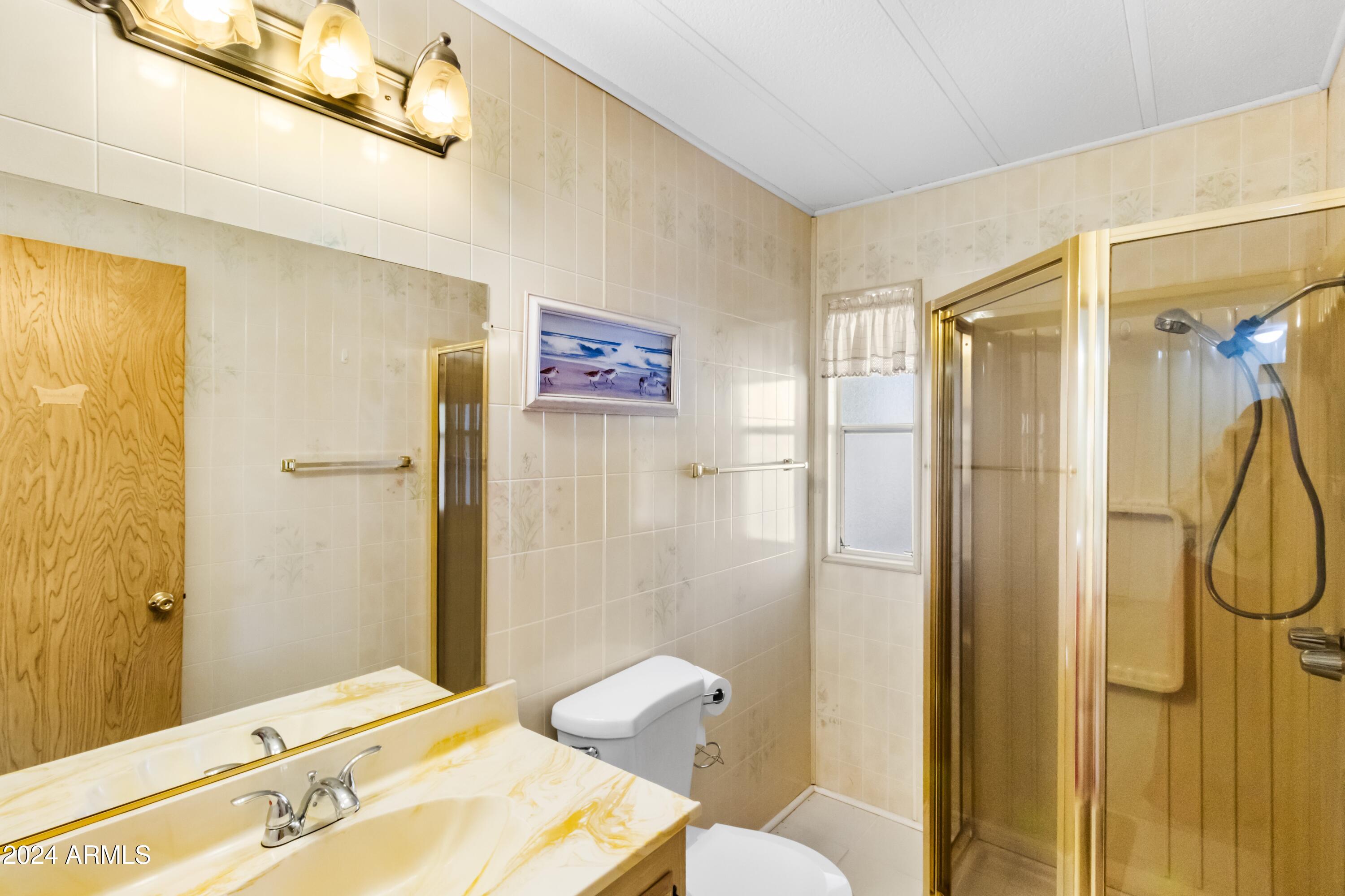2100 North Trekell Road, Unit 204 Casa Grande, AZ 85122 - Photo 18 of 27 a bathroom with a granite countertop sink toilet and shower