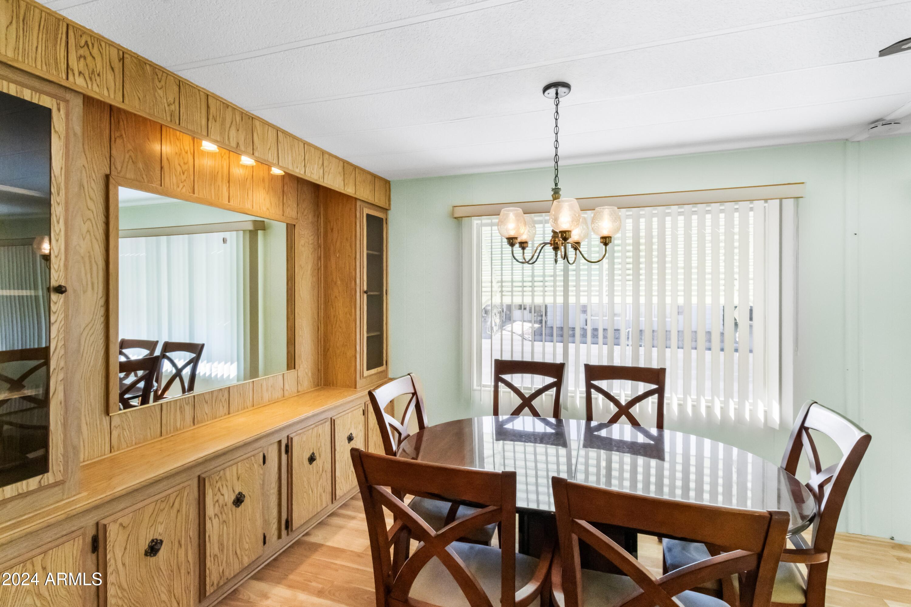 2100 North Trekell Road, Unit 204 Casa Grande, AZ 85122 - Photo 5 of 27 a view of a dining room and chandelier fan and wooden floor