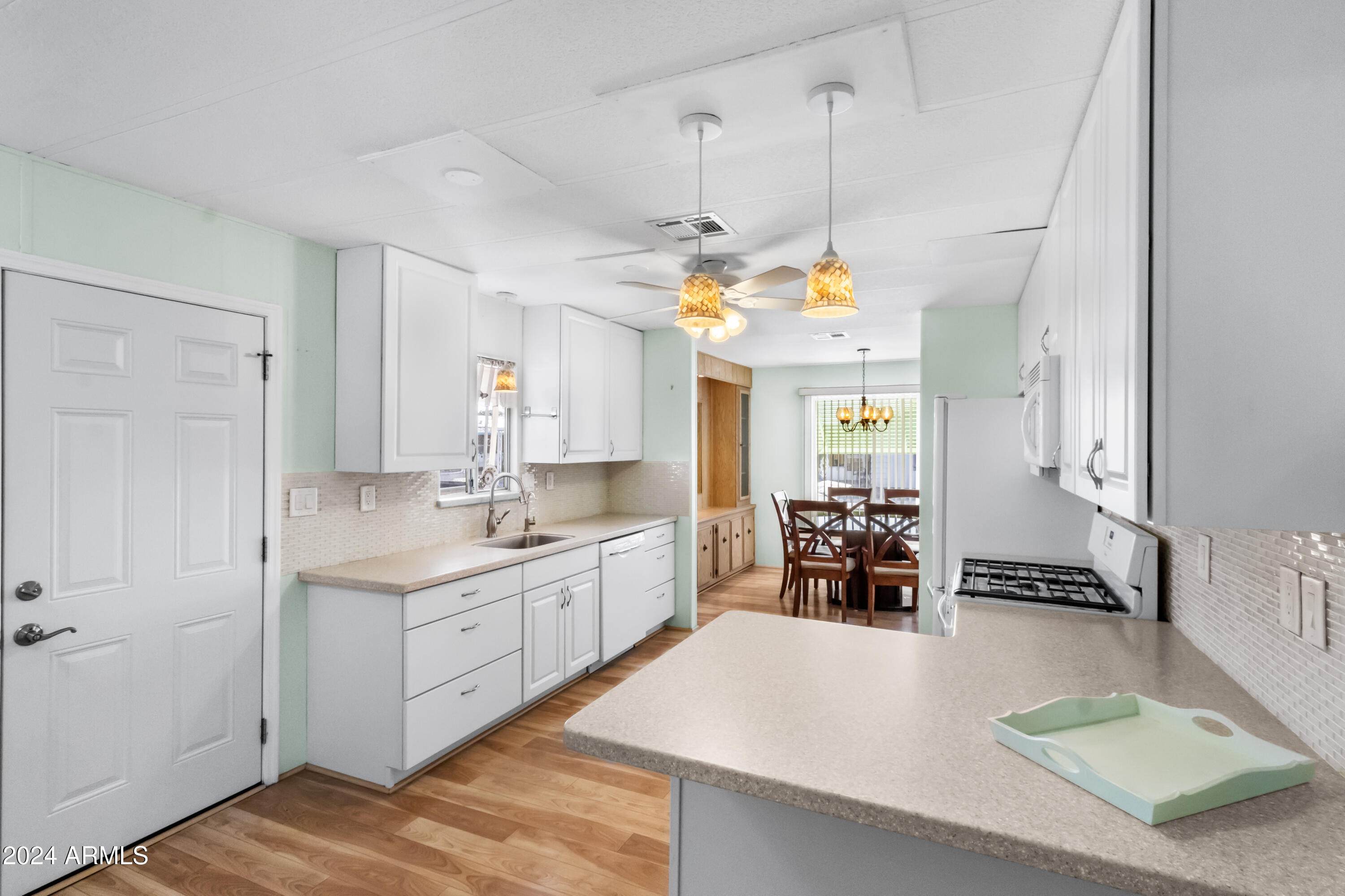 2100 North Trekell Road, Unit 204 Casa Grande, AZ 85122 - Photo 9 of 27 a kitchen with a sink a counter space and stainless steel appliances