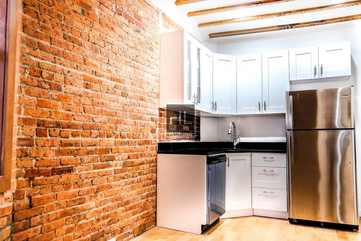 43 Cumberland Street, Unit UNT THREE Brooklyn, NY 11205 - Photo 2 of 9 a kitchen with granite countertop a sink cabinets and stainless steel appliances