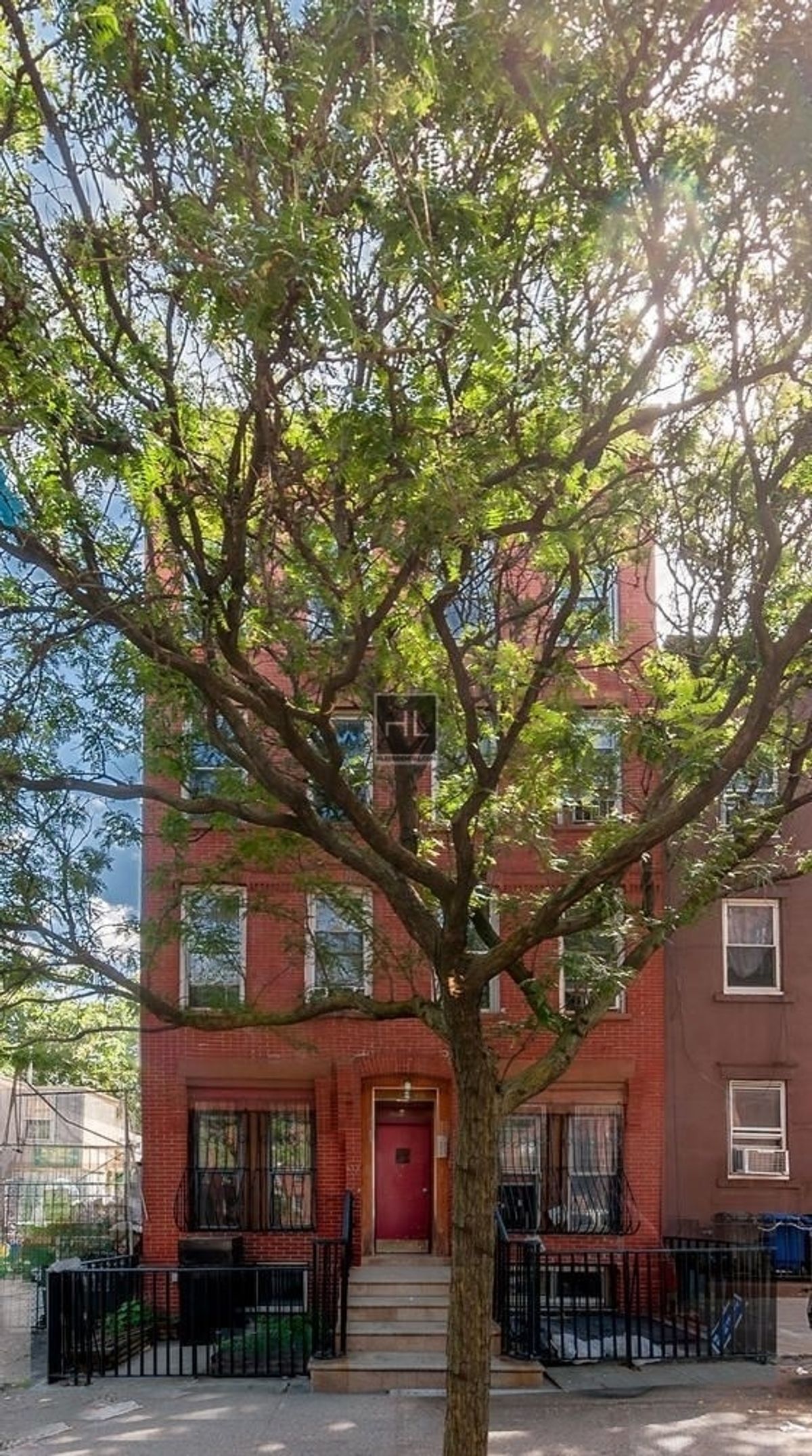 43 Cumberland Street, Unit UNT THREE Brooklyn, NY 11205 - Photo 8 of 9 a front view of a building with large trees