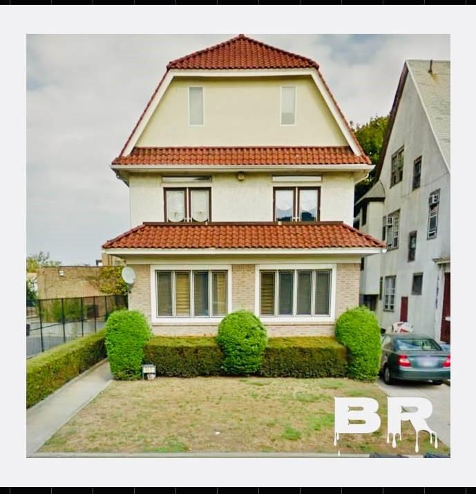 a view of a white house with a large windows and a yard