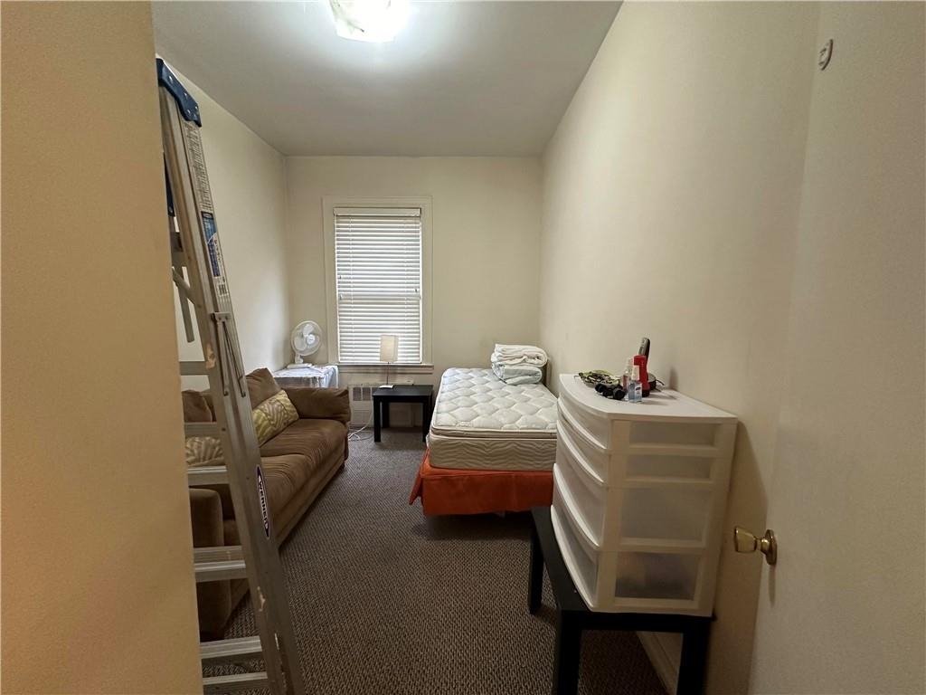 945 East 10th Street Brooklyn, NY 11230 - Photo 5 of 21 a bedroom with bed and a window