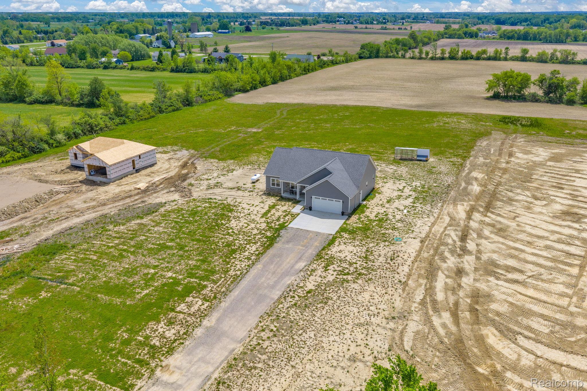 7600 Church Road Imlay City, MI 48444 - Photo 5 of 38 New construction residence with gray siding and an attached two-car garage